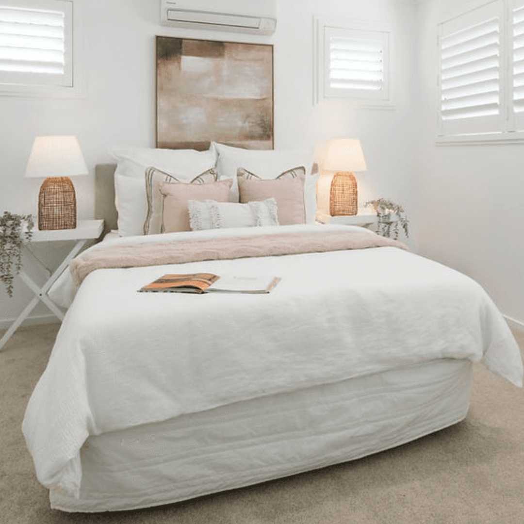 Styled one-bedroom apartment with a furnished bedroom and neutral bedding
